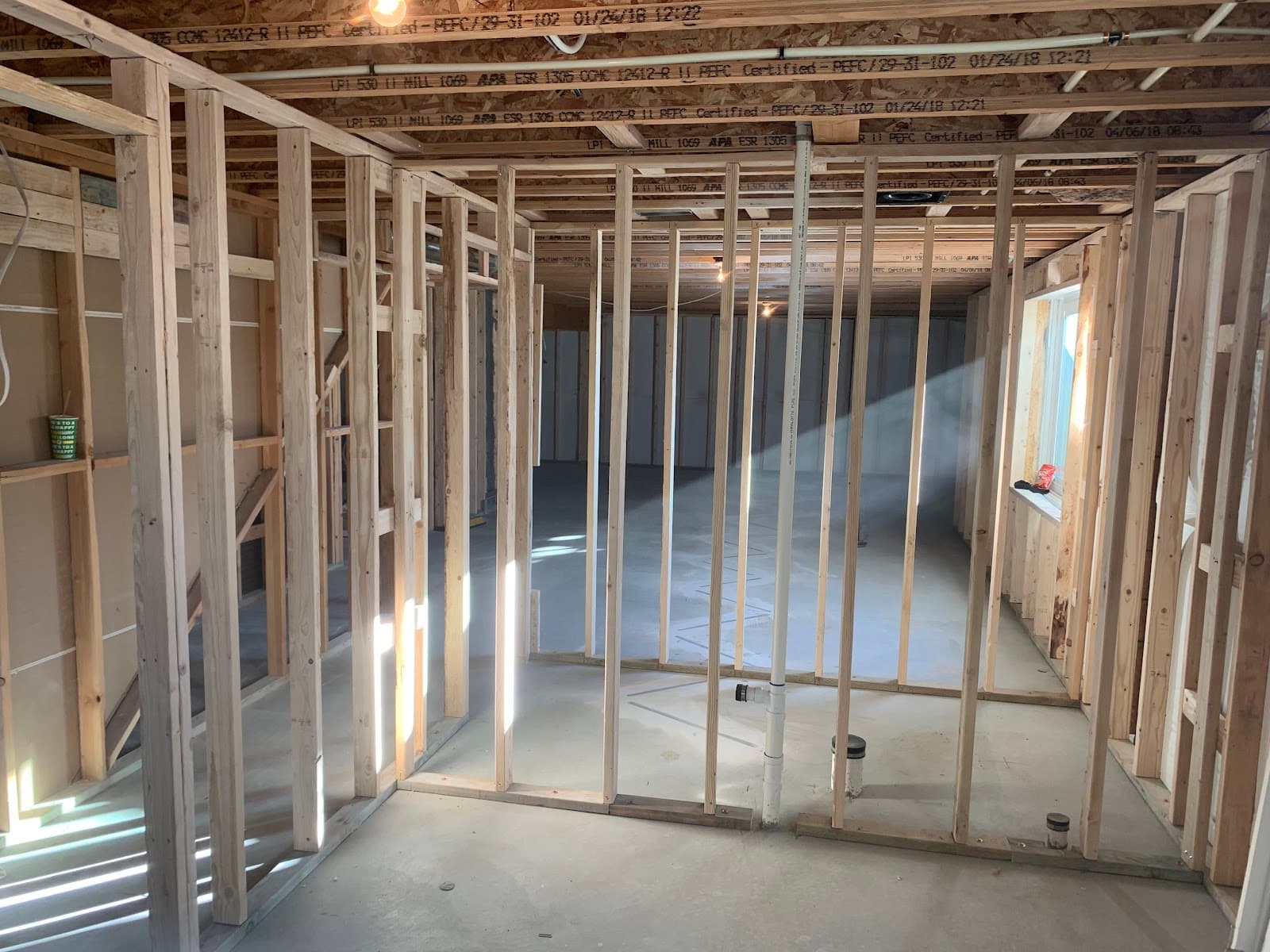Framed basement rooms showing straight, plumb stud walls by JS ProFinish
