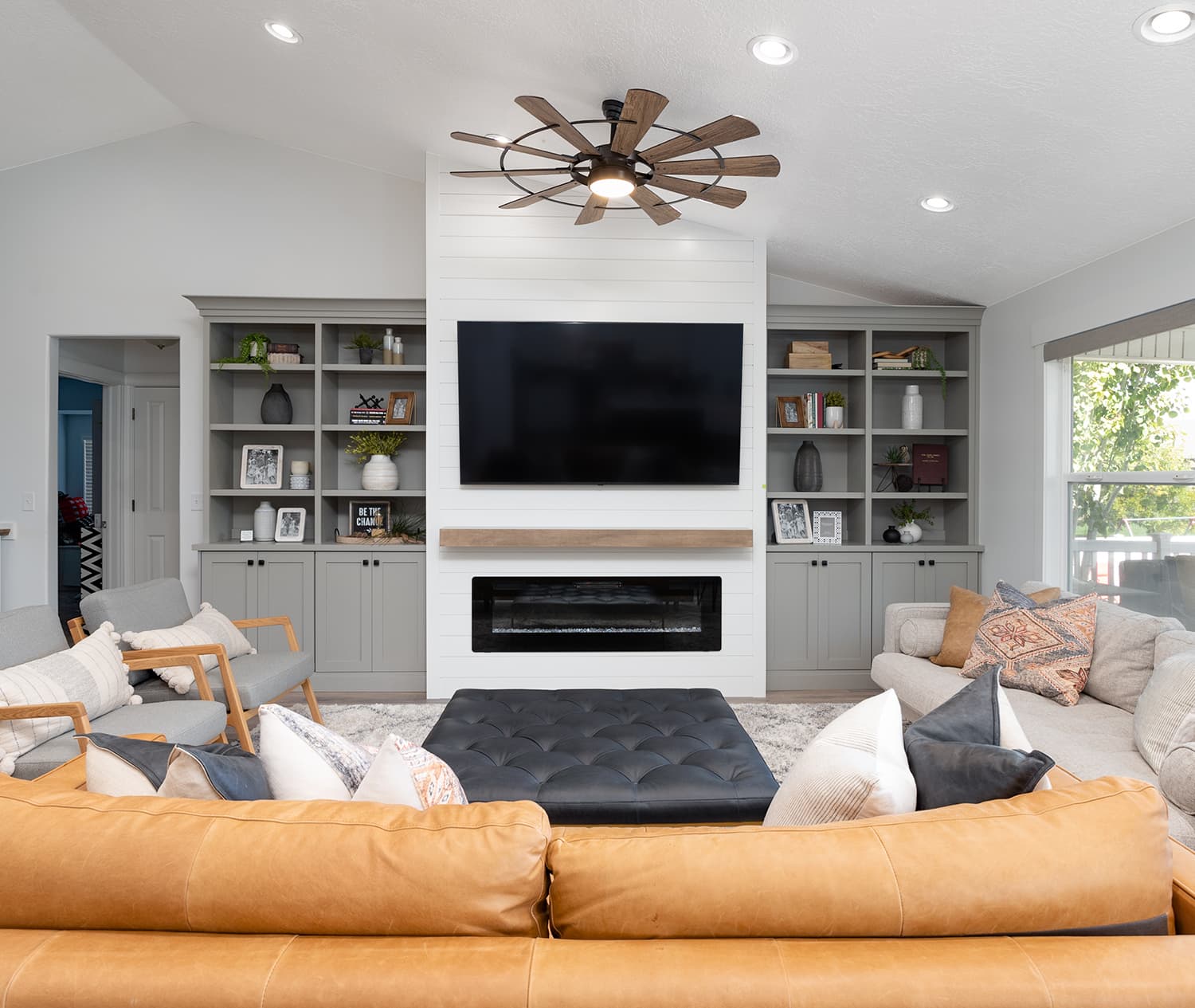 Family room finished by JS ProFinish with custom built-ins, shiplap fireplace wall, and floating mantel
