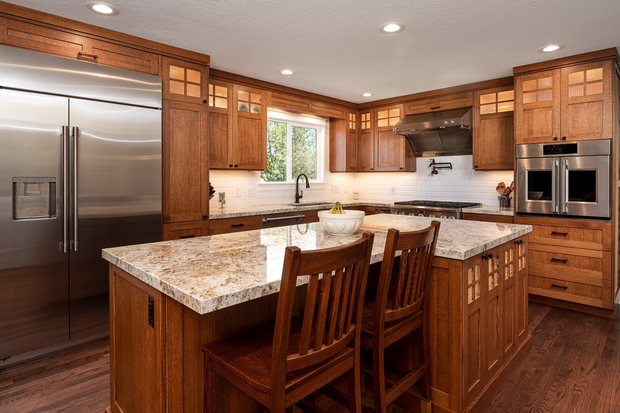 Craftsman-style kitchen by JS ProFinish with custom oak cabinetry and granite island