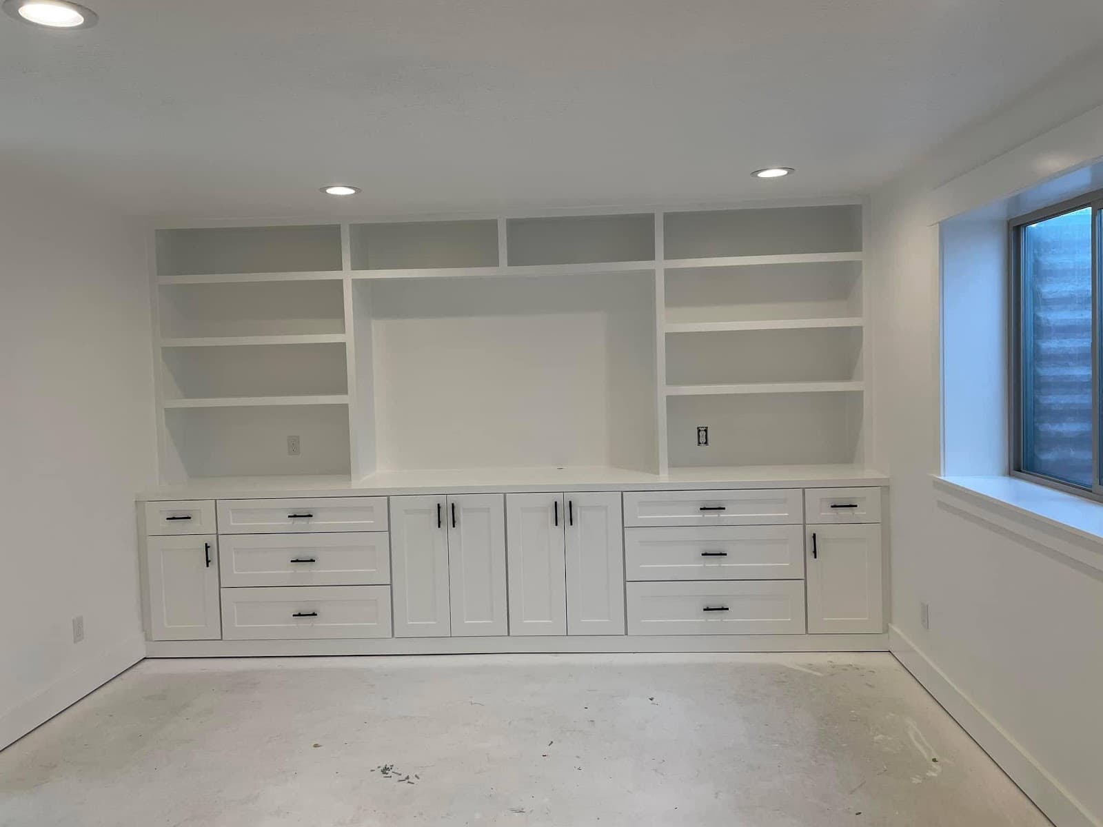 Wall of built-in desks and cabinets in a finished basement