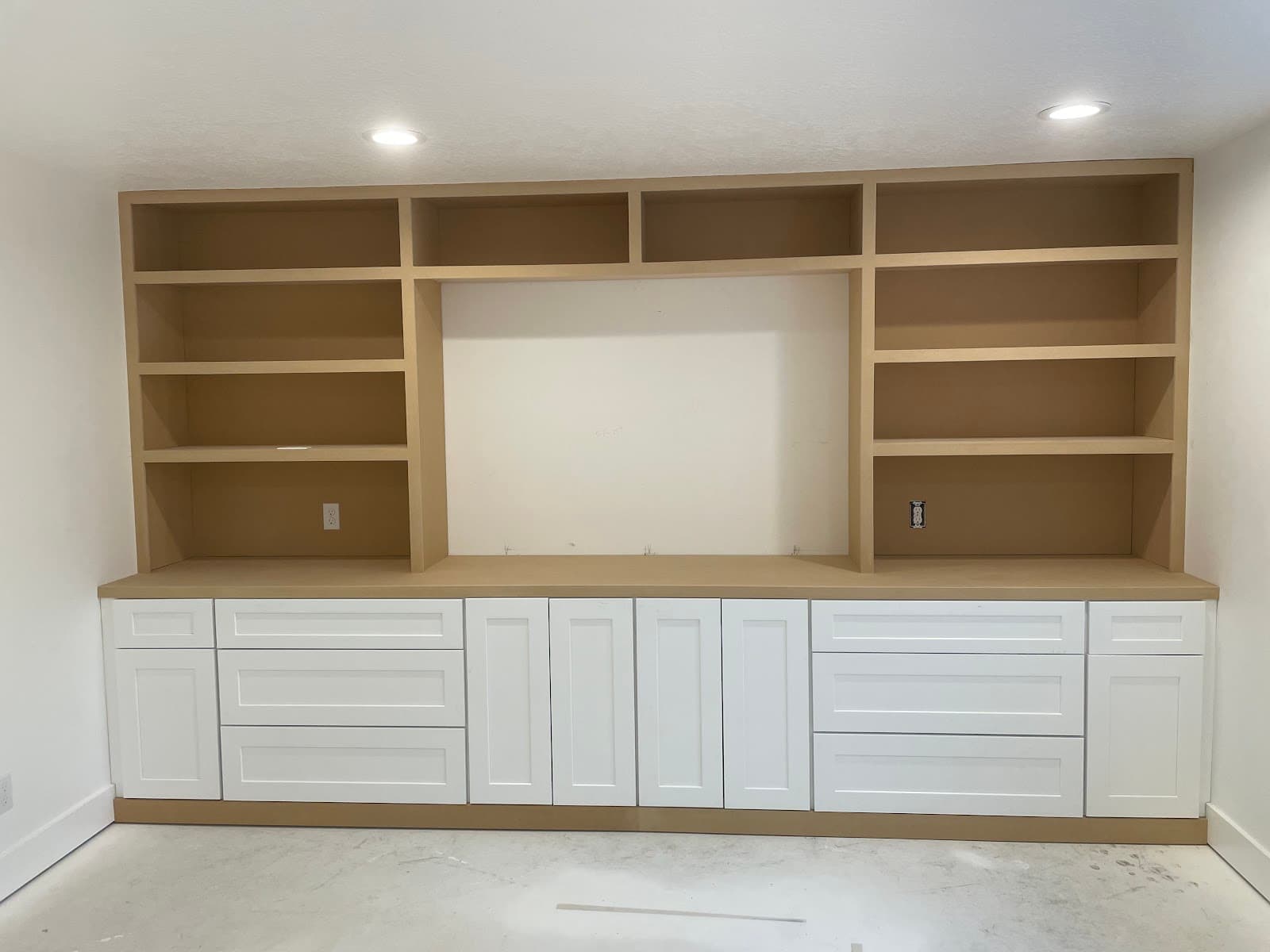 Built-in entertainment center with cabinets and shelving
