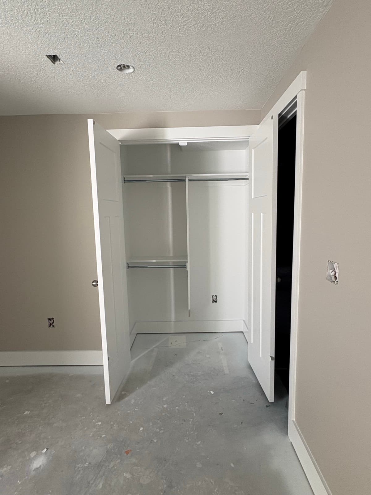 New closet doors and shelving installed in a finished room