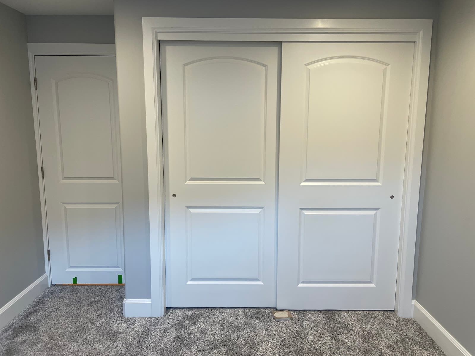 New closet doors and casing installed in a finished room