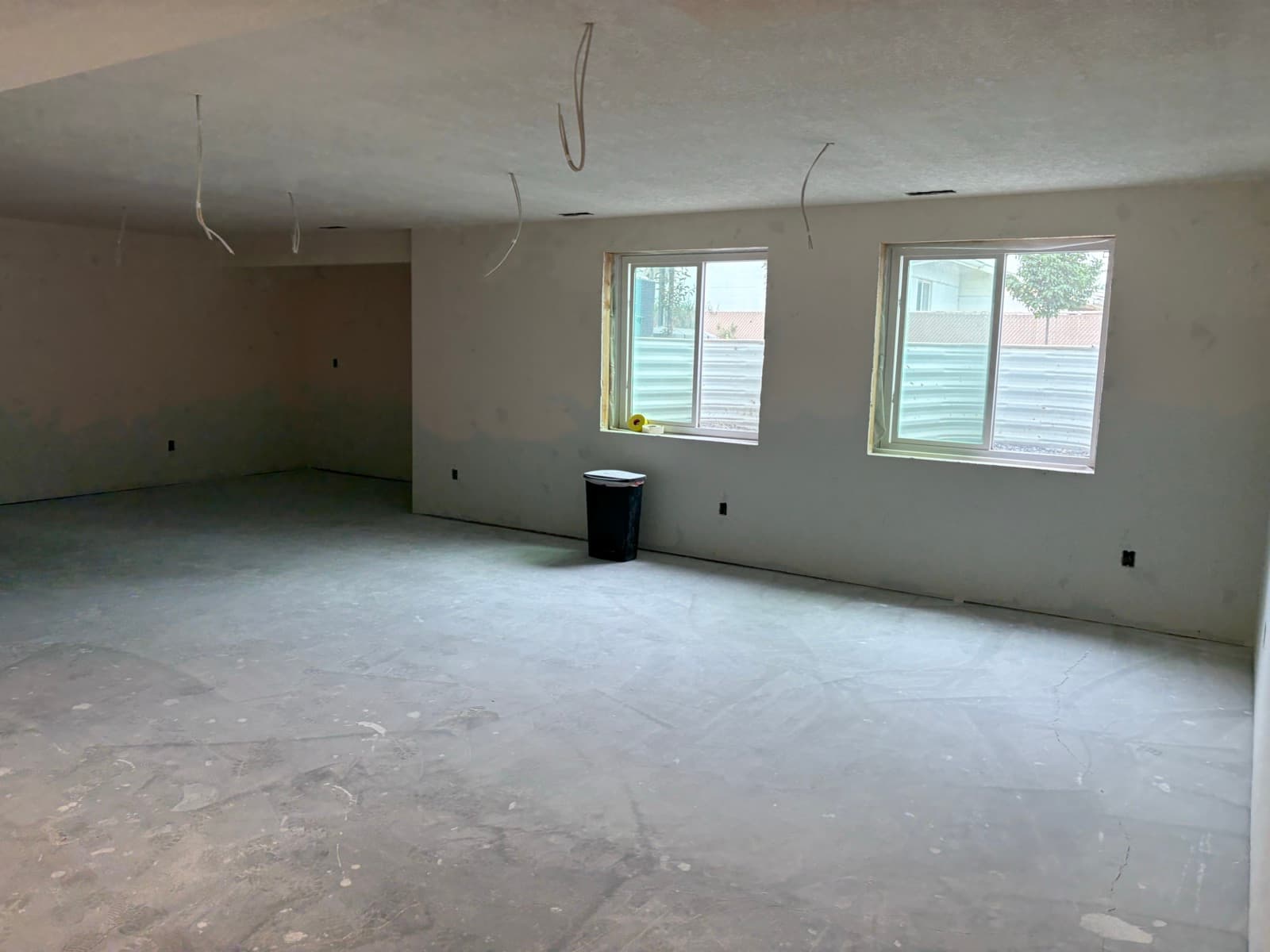 Drywall hung in a basement family room, ready for tape and mud