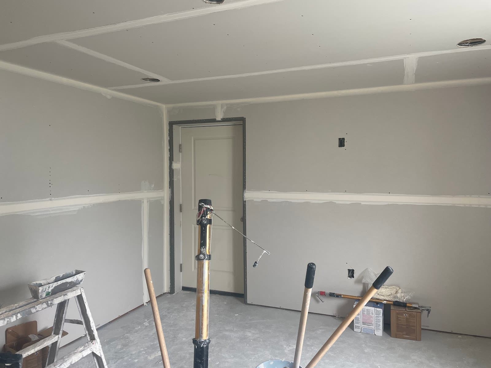 Basement room with drywall hung and taped, ready for texture and paint