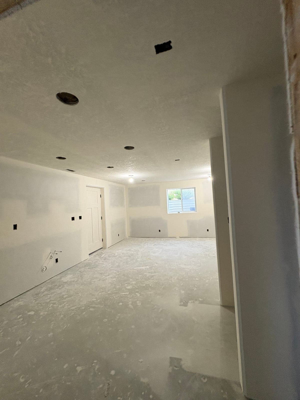 Family room with finished drywall and sprayed ceiling texture