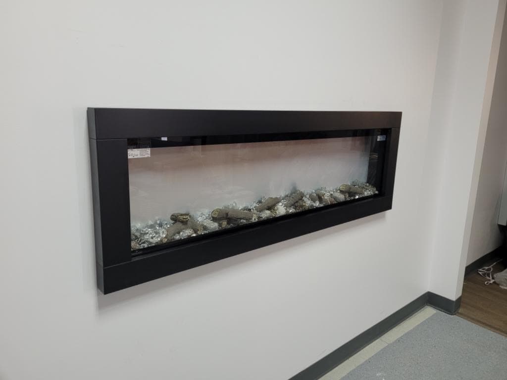 Electric fireplace feature wall built in a finished basement by JS ProFinish