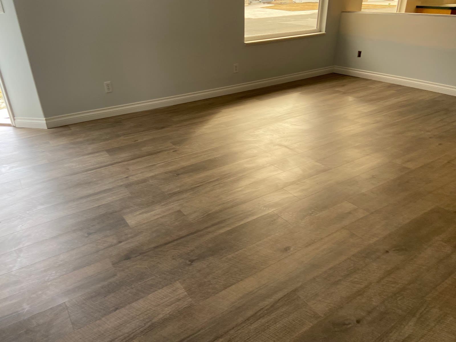 Wide plank LVP flooring installed in a finished basement